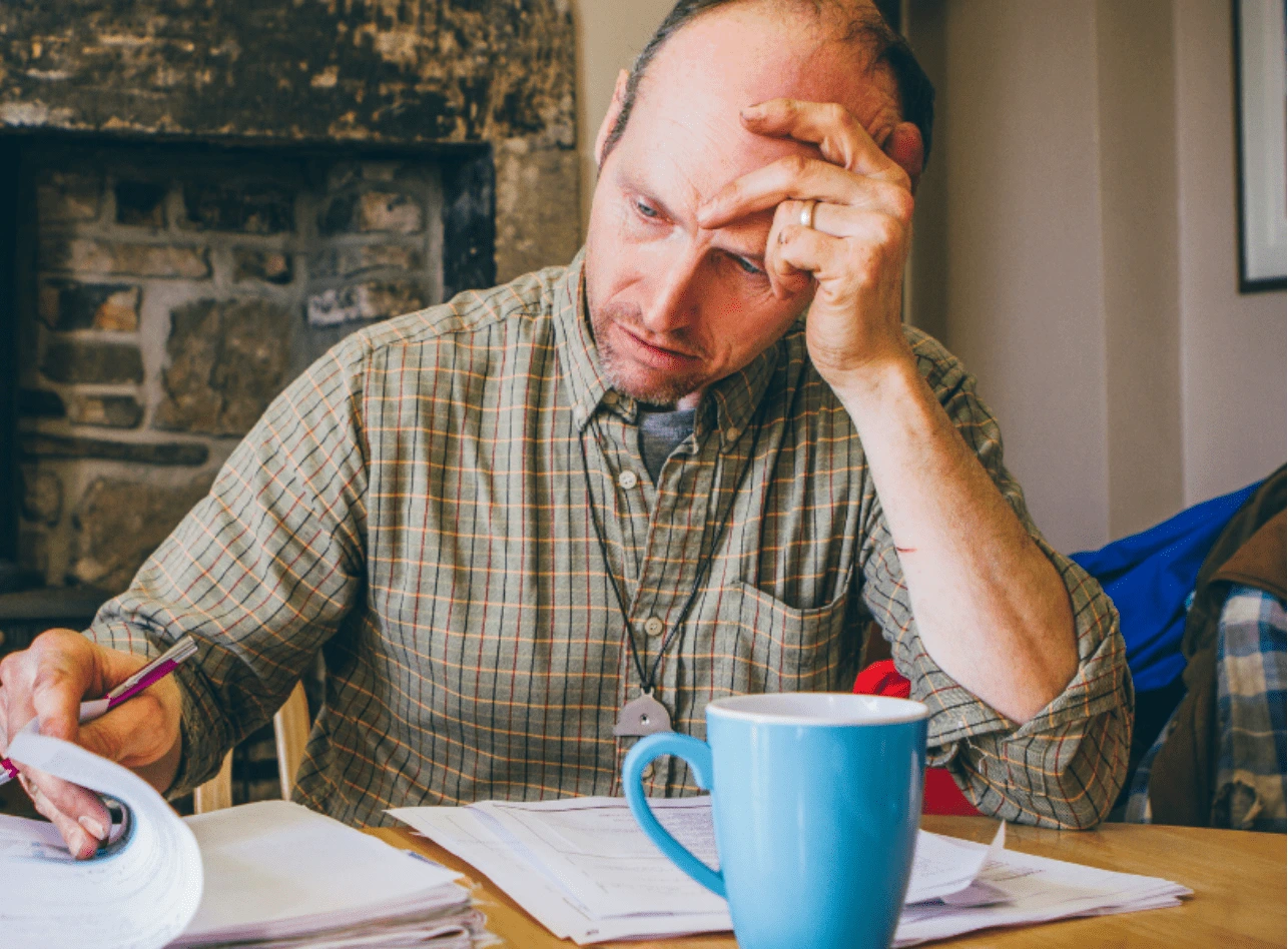 Farmer doing manual bookkeeping image
